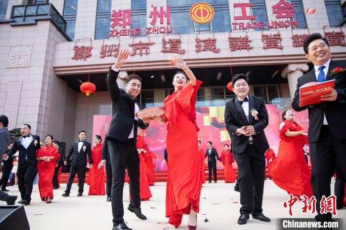 圖為新人為現(xiàn)場(chǎng)觀禮親友分撒喜糖?！⊥跬?攝