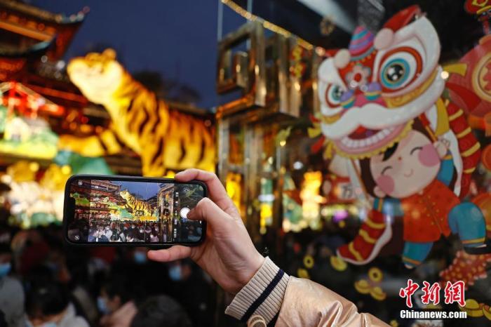 圖為游客用手機(jī)拍攝生肖虎燈。 殷立勤 攝