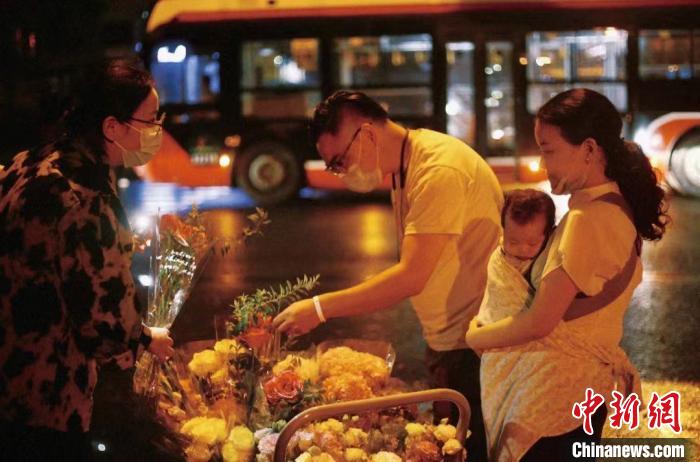 抱著襁褓中的孩子來(lái)買(mǎi)花的夫妻。　受訪者供圖