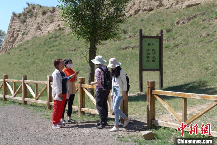 在巡查長城中，袁建琴為游客講解如何保護(hù)長城。袁建琴 供圖 受訪者袁建琴供圖