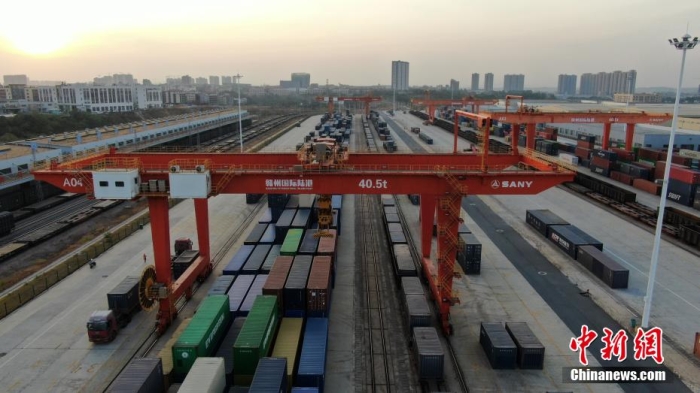 據(jù)了解，贛州國(guó)際陸港是全國(guó)第8個(gè)、也是全國(guó)革命老區(qū)唯一一個(gè)內(nèi)陸開(kāi)放口岸，目前已開(kāi)通5條鐵海聯(lián)運(yùn)“三同”班列線路，中歐(亞)班列線路覆蓋中亞5國(guó)和歐洲主要物流節(jié)點(diǎn)城市。圖為在夕陽(yáng)映照下，巨大的龍門(mén)塔吊正在忙碌地裝運(yùn)各色集裝箱。姜濤 攝